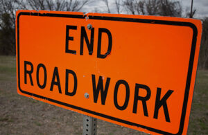 An orange road sign that reads, 'End Road Work'.