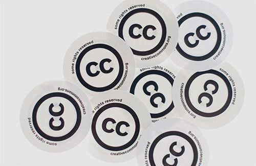 A photo of eight Creative Commons stickers arranged on a white background. Each sticker includes the Creative Commons 'two Cs in a circle' symbol with the words, 'Some rights reserved' and the CC website address.