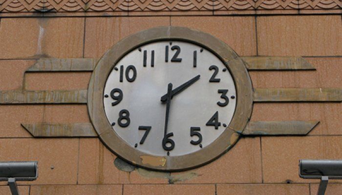 A photo of an art deco clock showing the time as 1:31. The clock features a white face with large black numbers and hour and minute hands.